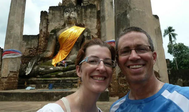 Henry and his wife smiling during a trip to Thailand